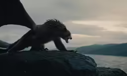 a monster creature is on top of a cliff