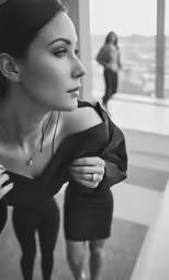 a woman in a dress looking down at something