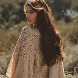 a woman is standing in some tall grass