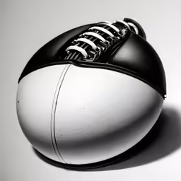 black and white football sitting on top of a gray table