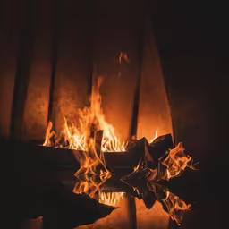 a close up shot of a blazing fire with an umbrella