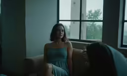 a girl sitting in a chair with another person