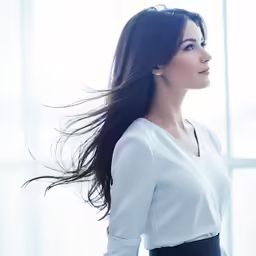 a woman in white shirt posing for a photo