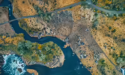 an aerial view of a river and land, as it is blue
