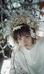 a woman with a floral crown on top of her head
