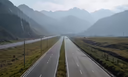 an empty highway in the mountains, near a freeway