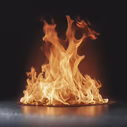 a close up shot of a flame on a black surface