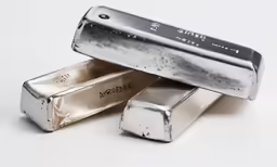 a group of silver bars on a white table