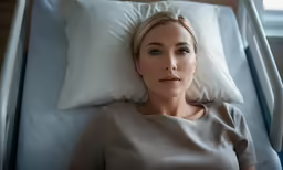 the woman laying in bed is sad and sleepy