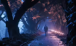 a man walking down a path next to some trees