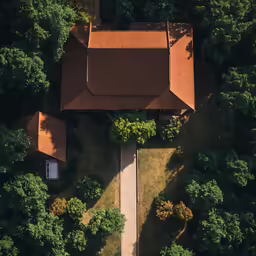 an overhead view of a brown cabin surrounded by trees