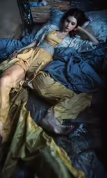 a woman laying on the bed in front of a bed sheet