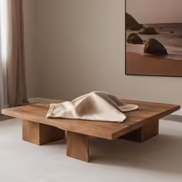 a blanket is sitting on a wooden table
