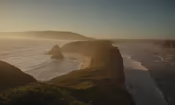the sun is setting over the beach at an island