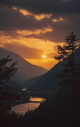 the sun rising over the mountains and body of water