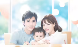 a couple sitting together with their child