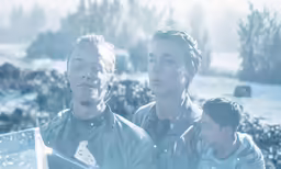 a group of young men standing next to each other
