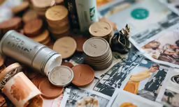 a number of different money and coins near one another
