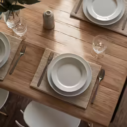 the place setting is set on the wooden table