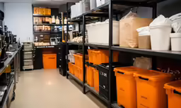shelves holding containers and storage bins with orange containers