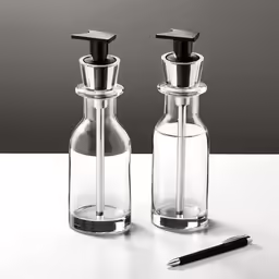 two pepper mill holders and a pen on a white table