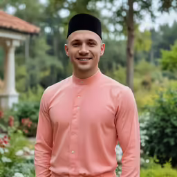 a young man is smiling for the camera