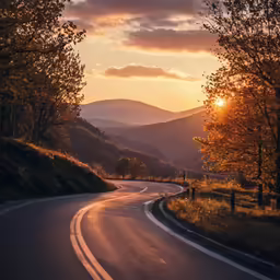 a street with curved road and mountains in the background