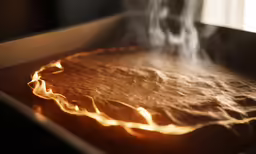 smoke rising from an oven that has been cooked