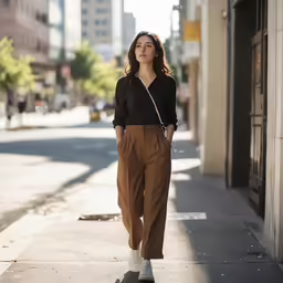 a woman is posing for a picture while walking down the street