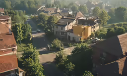 a city street with houses with green roofs
