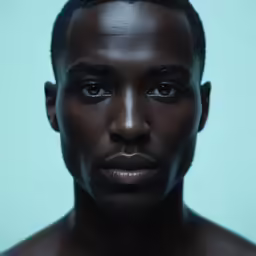 a man looking straight at the camera with only his black head