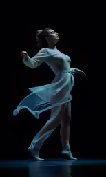 a woman wearing a white dress while dancing