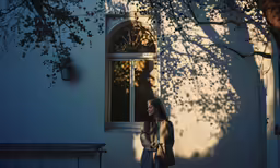 a woman is walking down the street by a building