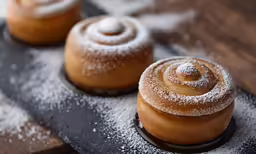 three different pastries with powdered sugar on them