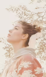 a woman looking up as the wind blows her hair in the wind