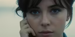 close up portrait of young woman with eye contact on cheek