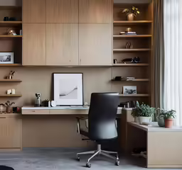 an office with a large book shelf and desk area