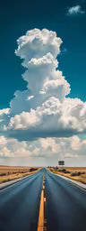 a lonely road has a street sign and clouds above