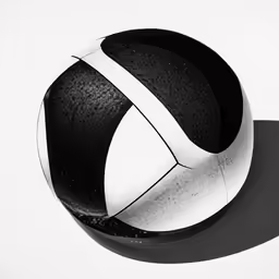a large black and white object is sitting on a surface