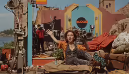 a woman posing for the camera with her arms in the air