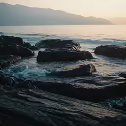 the rocky coastline is covered in ocean waves