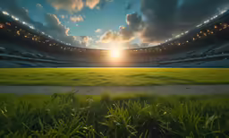 the sun sets in the background with a field in front