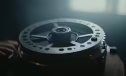 a metal disk holding a piece of machinery