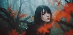 a woman in black is standing in the woods