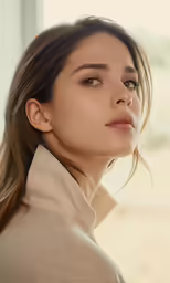a woman in a turtle neck shirt posing for a photo