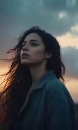 a beautiful young woman with long hair standing in the sky