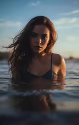 a woman is swimming in the water at the beach
