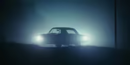 an old pickup truck sits on the edge of a road at night
