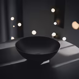 an empty black bowl sitting on a table
