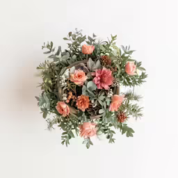 the wall is covered with pink flowers and greenery